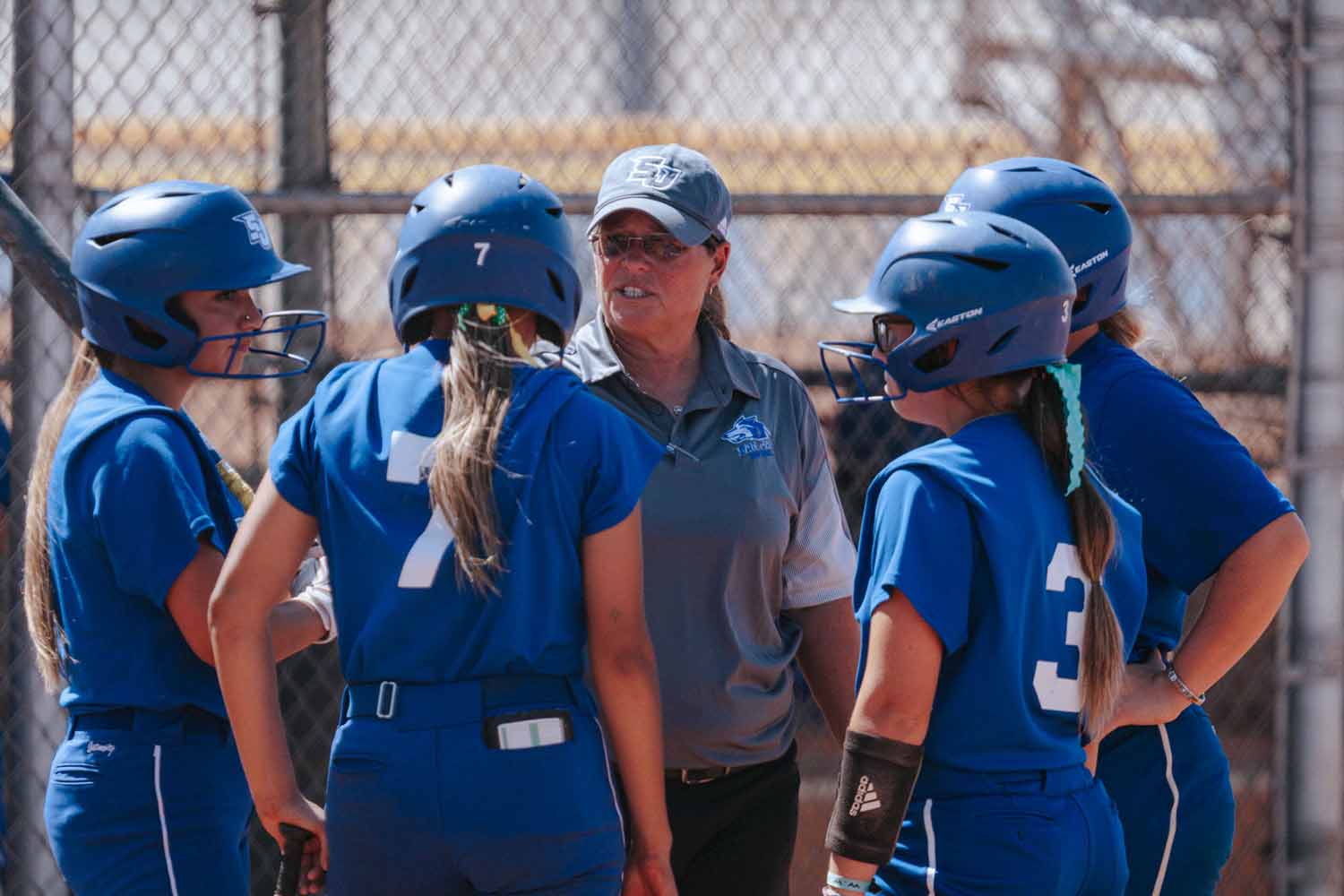 softball team and coach