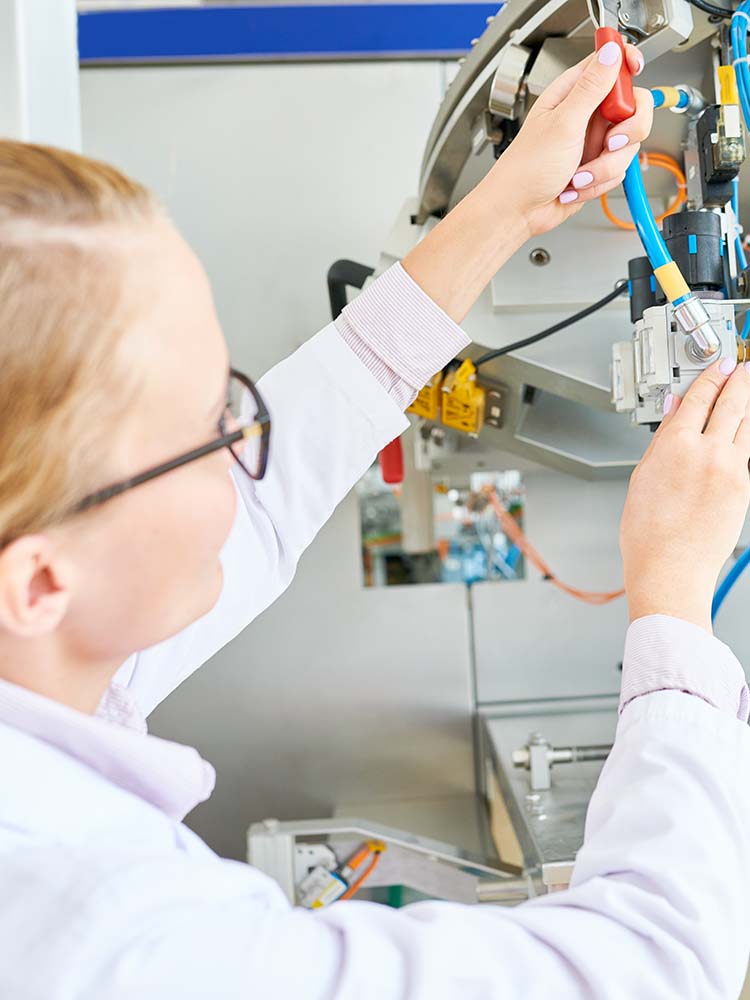 Woman working on medical equipment.