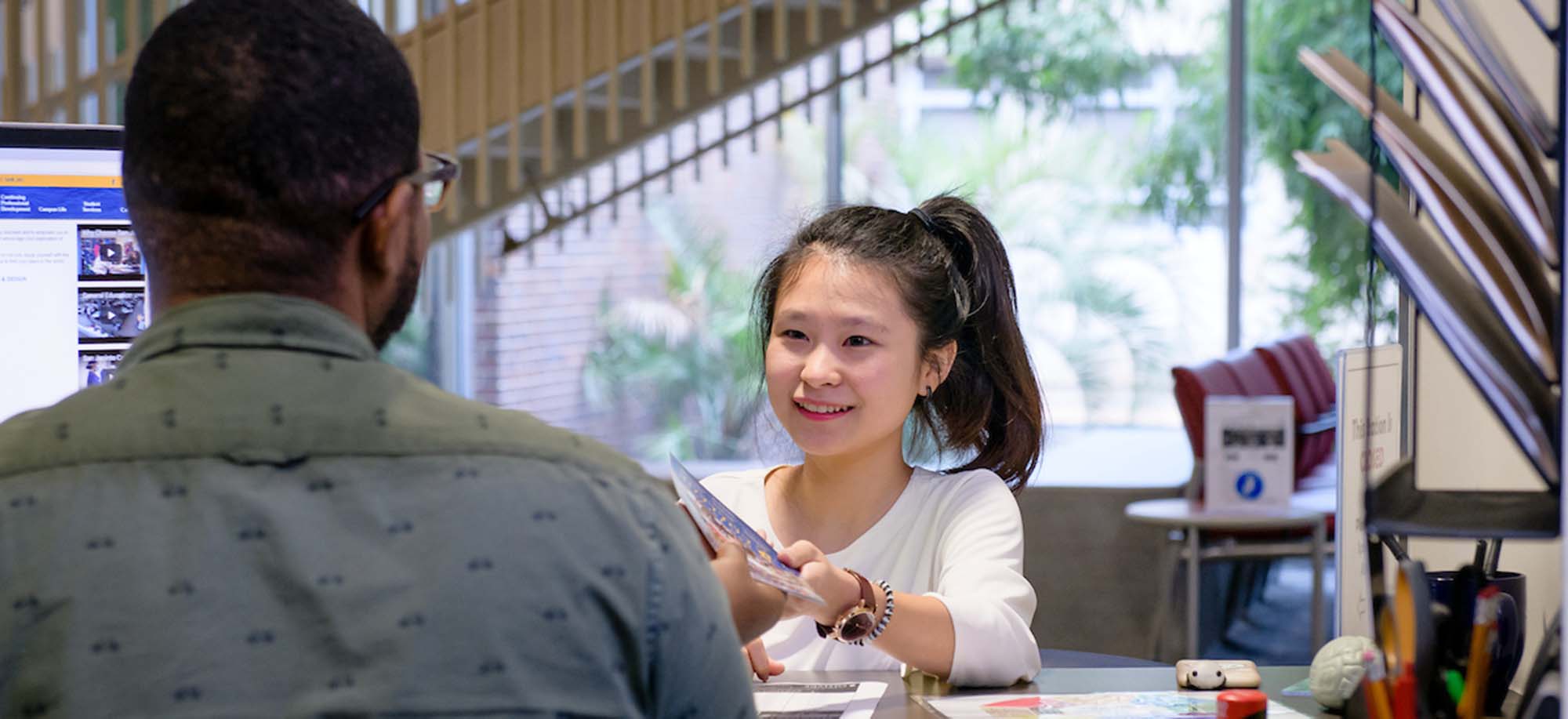 girl speaking with worker