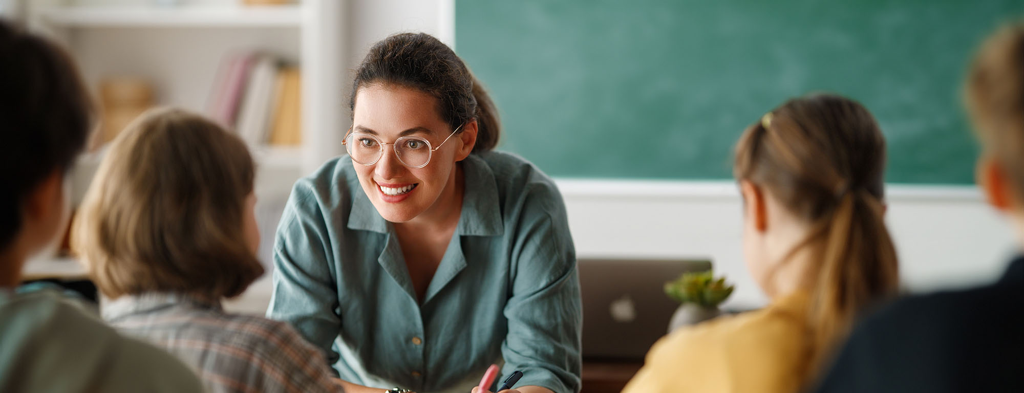 Teacher in front of class whiteboard