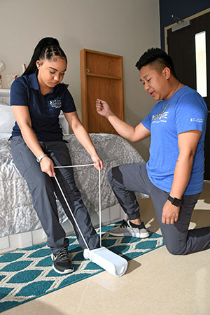 Two San Jacinto College occupational therapy assistant students practicing skills