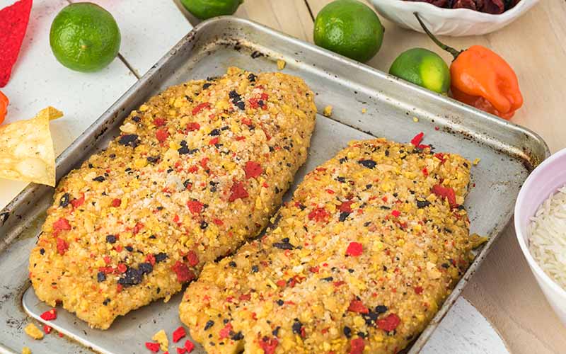 Seasoned cooked tilapia on a baking sheet