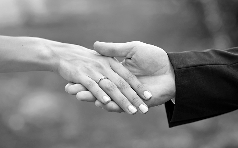 Close-up of bride and groom's hands together